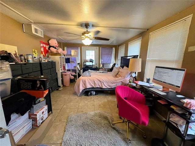 314 W Bordelon St, Gonzales, LA 70737 - tiled bedroom featuring a desk, a ceiling fan, and cooling unit