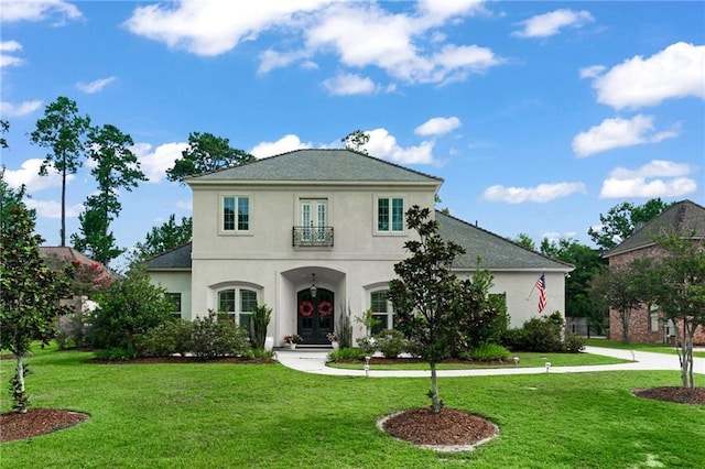 331 Memphis Trce, Covington, LA 70433 - view of front facade featuring stucco siding, a front lawn, and french doors