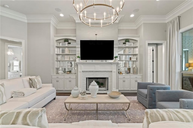 331 Memphis Trce, Covington, LA 70433 - living room featuring a chandelier, ornamental molding, a fireplace, wood finished floors, and built in shelves