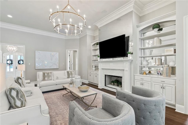 331 Memphis Trce, Covington, LA 70433 - living room featuring a chandelier, ornamental molding, a fireplace, dark wood-type flooring, and french doors