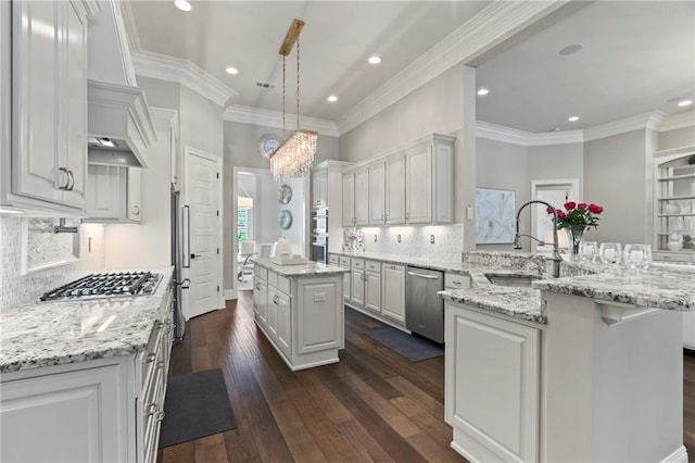 331 Memphis Trce, Covington, LA 70433 - kitchen featuring stainless steel appliances, a peninsula, a sink, white cabinetry, and a center island