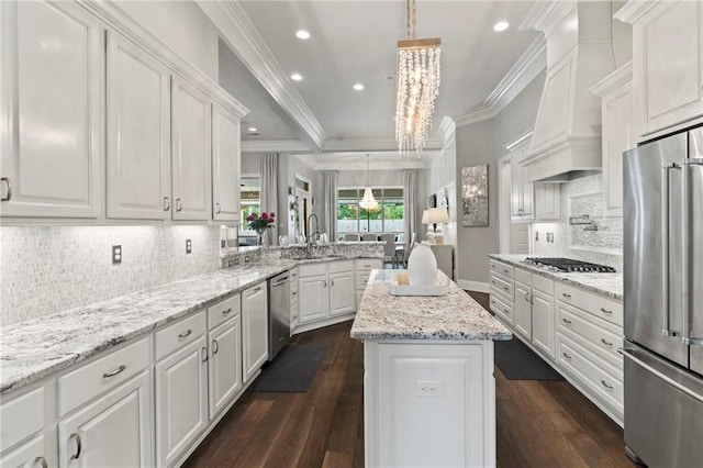 331 Memphis Trce, Covington, LA 70433 - kitchen featuring appliances with stainless steel finishes, a sink, a peninsula, white cabinets, and ornamental molding
