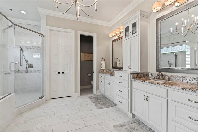331 Memphis Trce, Covington, LA 70433 - full bathroom featuring a chandelier, a shower stall, vanity, marble look tile flooring, and ornamental molding
