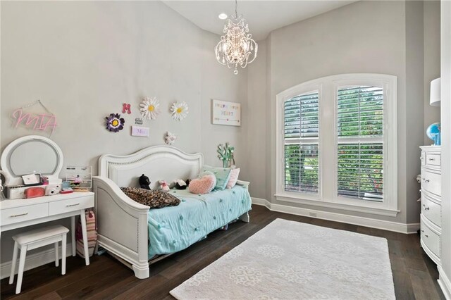 331 Memphis Trce, Covington, LA 70433 - bedroom with a chandelier and dark wood-style flooring