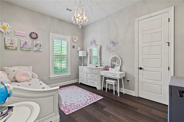 331 Memphis Trce, Covington, LA 70433 - bedroom with dark wood-style flooring and a chandelier