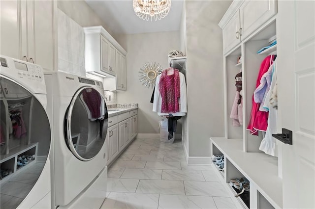 331 Memphis Trce, Covington, LA 70433 - laundry room with washer and dryer, cabinet space, light marble finish flooring, a chandelier, and baseboards
