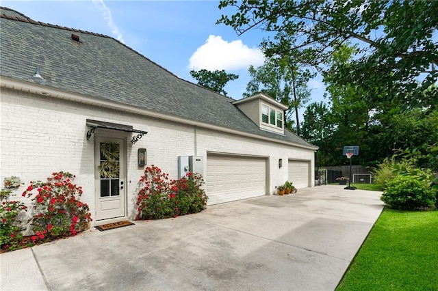 331 Memphis Trce, Covington, LA 70433 - view of side of home with driveway, roof with shingles, brick siding, and a garage