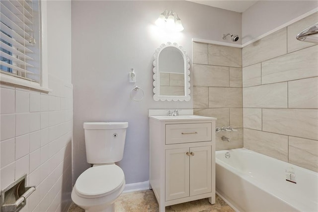 5908 York St, Metairie, LA 70003 - full bathroom featuring toilet, vanity, shower / bathtub combination, tile walls, and tile patterned flooring