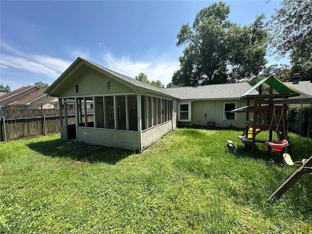2216 Teal St, Slidell, LA 70460 - back of house with a sunroom, a playground, and roof with shingles
