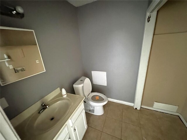 2216 Teal St, Slidell, LA 70460 - half bath with toilet, vanity, tile patterned flooring, and baseboards