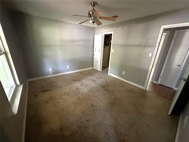 2216 Teal St, Slidell, LA 70460 - unfurnished bedroom featuring baseboards, carpet floors, a walk in closet, a closet, and a ceiling fan