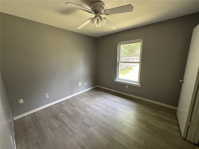 2216 Teal St, Slidell, LA 70460 - unfurnished room featuring a ceiling fan, dark wood-style floors, a textured ceiling, and baseboards