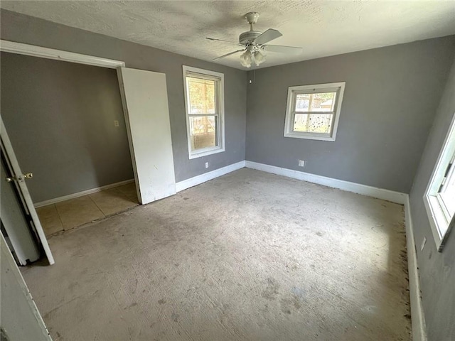 2216 Teal St, Slidell, LA 70460 - unfurnished bedroom featuring baseboards, a ceiling fan, and a textured ceiling