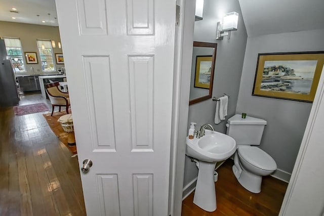 1126 Toledano St, New Orleans, LA 70115 - bathroom with wood finished floors, baseboards, and toilet