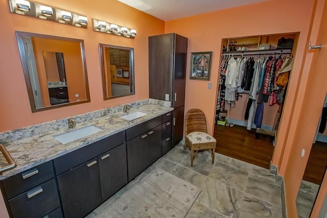 1126 Toledano St, New Orleans, LA 70115 - full bath with double vanity, a spacious closet, and wood finished floors