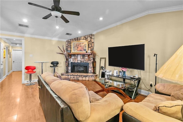 7542 Lehigh St, New Orleans, LA 70127 - living area with vaulted ceiling, baseboards, light wood-type flooring, crown molding, and a stone fireplace