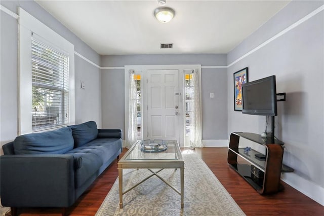 4709-11 Coliseum St, New Orleans, LA 70115 - living room with dark wood-style flooring and baseboards