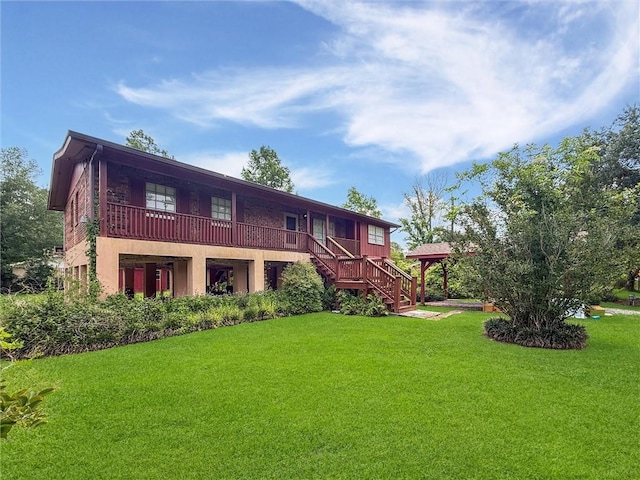 34159 Tupelo Ln, Slidell, LA 70460 - rear view of property featuring a gazebo, a lawn, and stairway