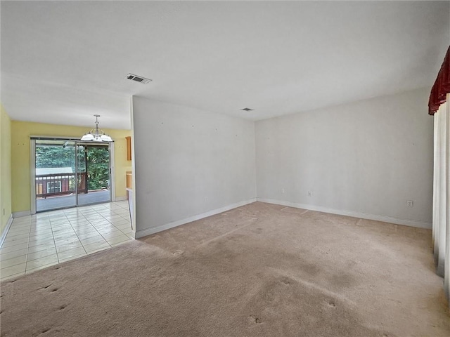 34159 Tupelo Ln, Slidell, LA 70460 - spare room with light colored carpet, a chandelier, and baseboards