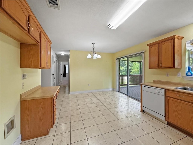 34159 Tupelo Ln, Slidell, LA 70460 - kitchen featuring white dishwasher, a chandelier, light countertops, light tile patterned flooring, and decorative light fixtures