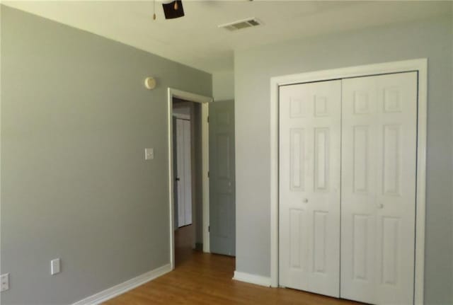 70305 I St, Covington, LA 70433 - unfurnished bedroom featuring wood finished floors, a closet, baseboards, and a ceiling fan