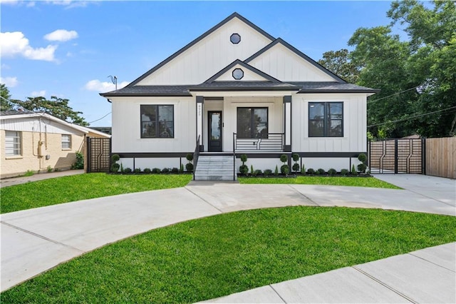 8925 25th St, Metairie, LA 70003 - modern inspired farmhouse with board and batten siding, a shingled roof, and covered porch