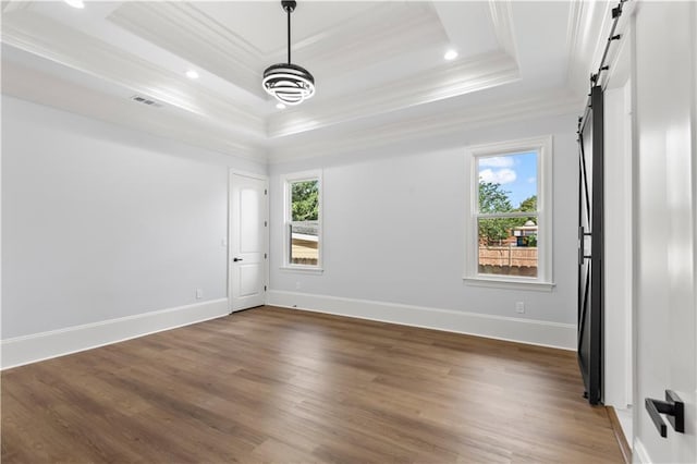 8925 25th St, Metairie, LA 70003 - unfurnished room featuring a barn door, a tray ceiling, crown molding, wood finished floors, and recessed lighting
