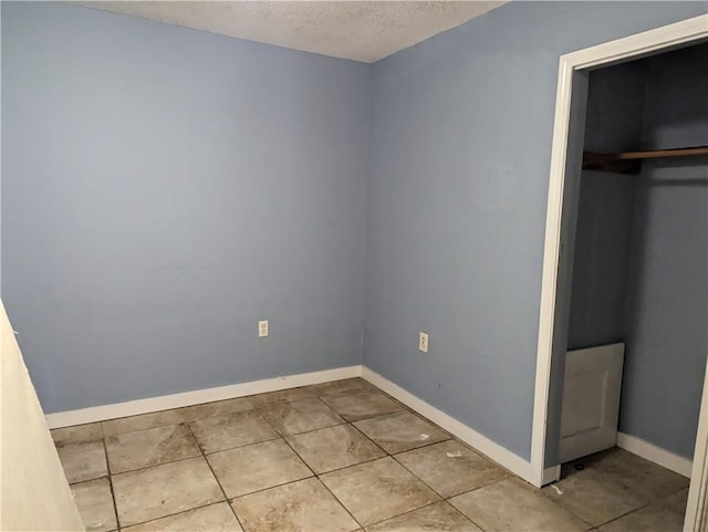 3127 Effie St, Slidell, LA 70458 - unfurnished bedroom with a textured ceiling, a closet, and tile patterned flooring
