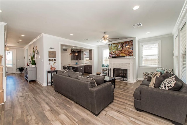2329 Bradbury Pl, Covington, LA 70433 - living room with crown molding, a ceiling fan, light wood-type flooring, recessed lighting, and plenty of natural light