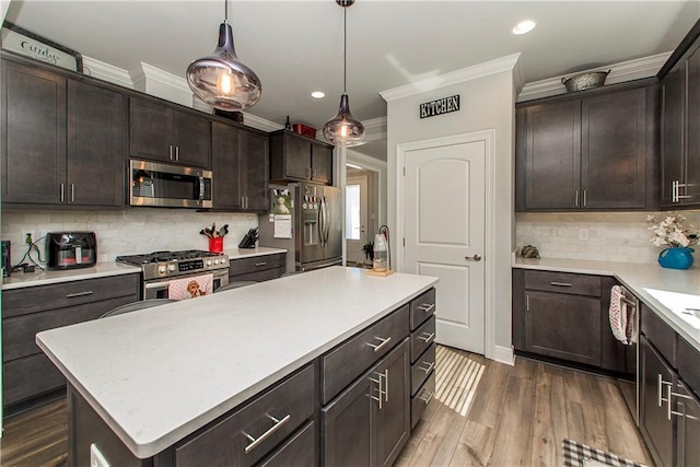 2329 Bradbury Pl, Covington, LA 70433 - kitchen featuring stainless steel appliances, ornamental molding, dark brown cabinets, light countertops, and decorative backsplash