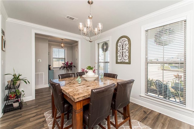 2329 Bradbury Pl, Covington, LA 70433 - dining room with a chandelier, dark wood finished floors, and ornamental molding