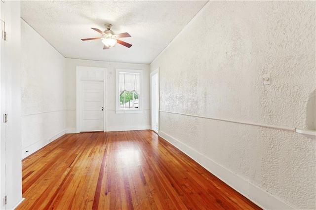 3141 Ponce De Leon St Unit 7, New Orleans, LA 70119 - unfurnished room with a ceiling fan, a textured wall, hardwood / wood-style floors, and a textured ceiling