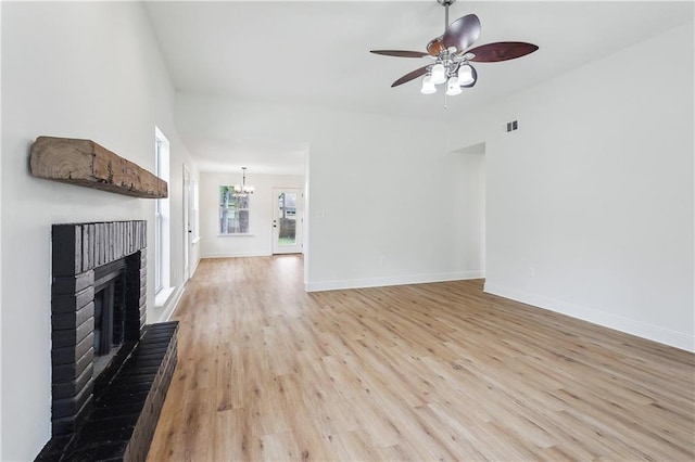 625 Woodridge Blvd, Mandeville, LA 70471 - unfurnished living room with a fireplace, light wood-type flooring, a ceiling fan, and baseboards