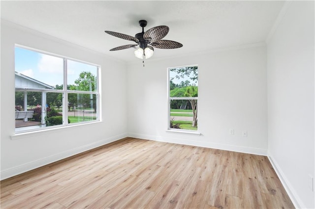 625 Woodridge Blvd, Mandeville, LA 70471 - empty room with ornamental molding, plenty of natural light, light wood-type flooring, a ceiling fan, and baseboards