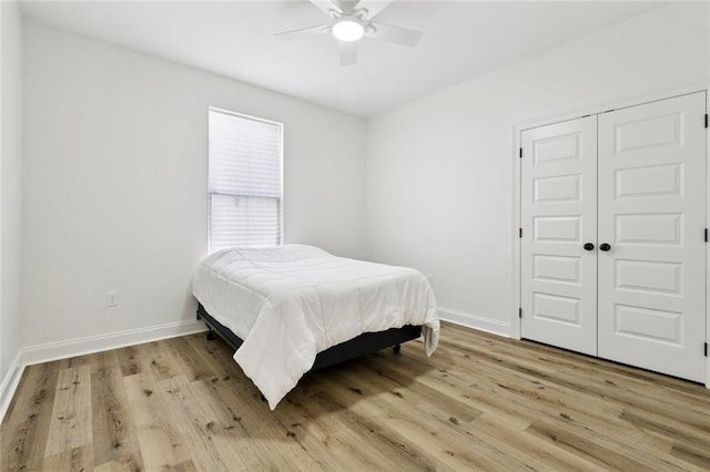 7211 Claiborne Ct, Arabi, LA 70032 - bedroom with light wood finished floors, baseboards, a closet, and a ceiling fan