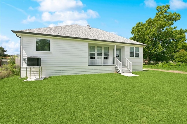 7211 Claiborne Ct, Arabi, LA 70032 - rear view of house featuring covered porch, a yard, central air condition unit, and a shingled roof