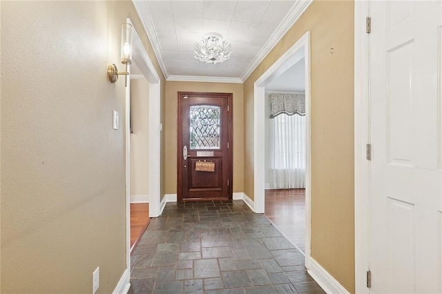 547 Jewel St, New Orleans, LA 70124 - foyer entrance featuring stone tile floors, a chandelier, baseboards, and ornamental molding