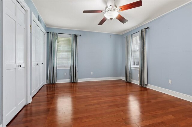 547 Jewel St, New Orleans, LA 70124 - unfurnished bedroom with multiple windows, crown molding, wood finished floors, baseboards, and a ceiling fan