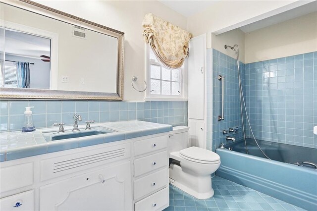 547 Jewel St, New Orleans, LA 70124 - full bathroom with tile patterned flooring, vanity, shower / bathtub combination, toilet, and decorative backsplash