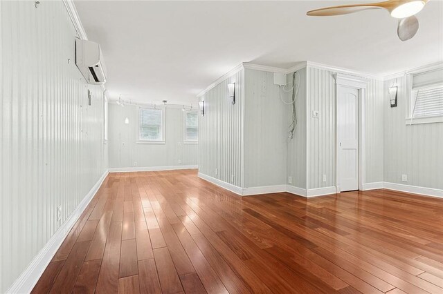 547 Jewel St, New Orleans, LA 70124 - spare room featuring hardwood / wood-style floors, a wall mounted air conditioner, a ceiling fan, baseboards, and crown molding