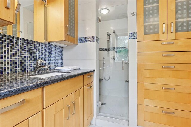 547 Jewel St, New Orleans, LA 70124 - bathroom with a shower stall, vanity, and backsplash