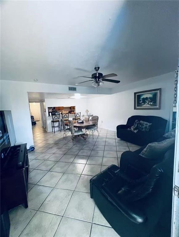 4401 Lefkoe St, Metairie, LA 70006 - living area with light tile patterned floors and ceiling fan