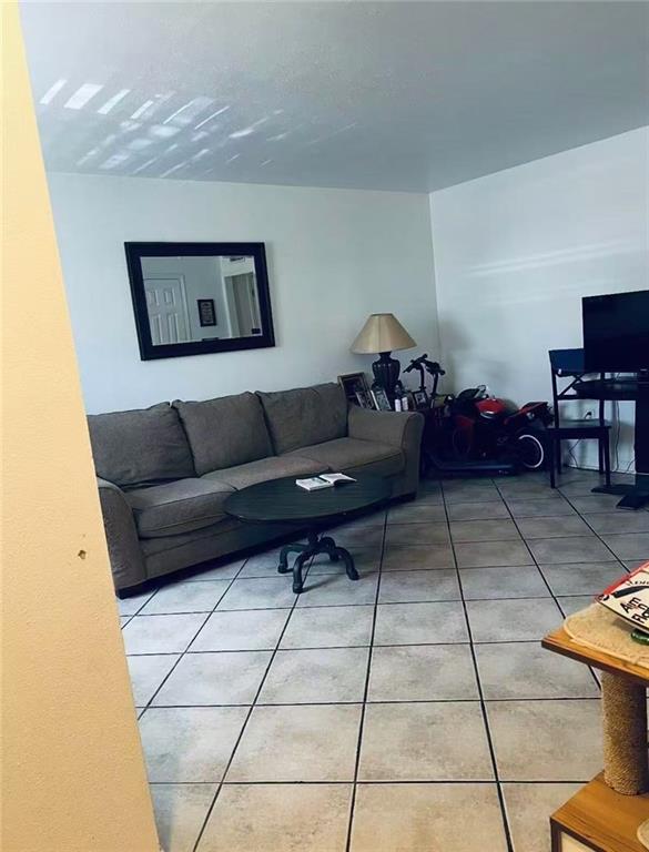 4401 Lefkoe St, Metairie, LA 70006 - living room featuring light tile patterned floors