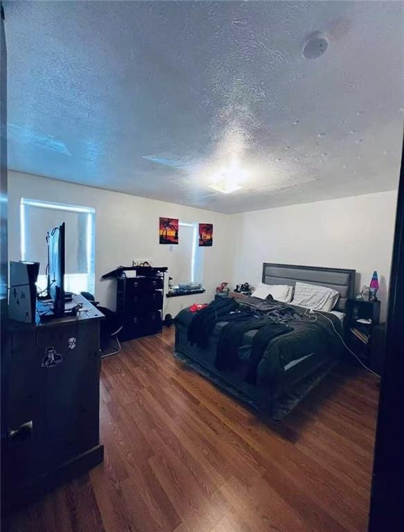 4401 Lefkoe St, Metairie, LA 70006 - bedroom featuring a textured ceiling and dark wood-style floors