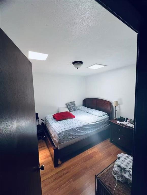 4401 Lefkoe St, Metairie, LA 70006 - bedroom with wood finished floors and a skylight