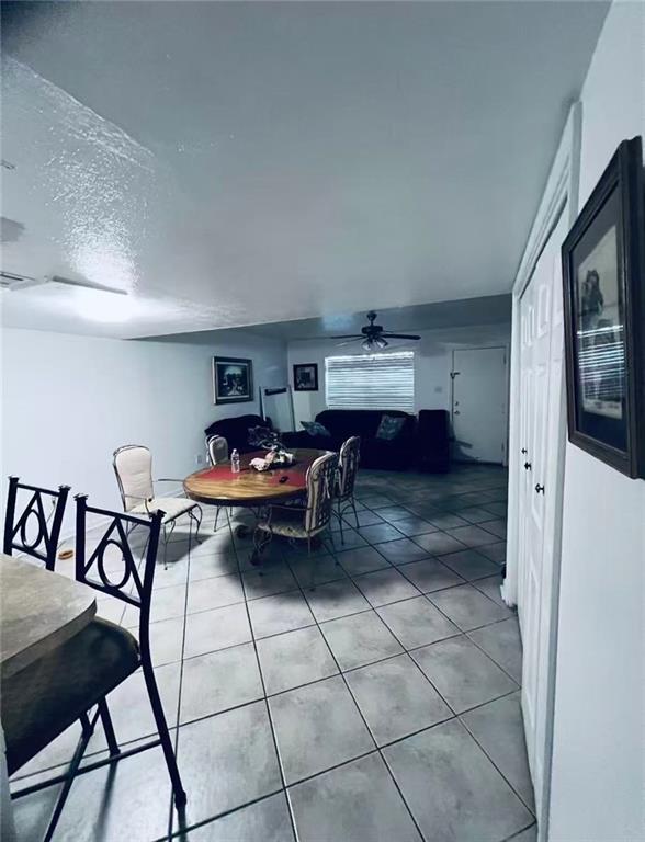 4401 Lefkoe St, Metairie, LA 70006 - tiled dining space with ceiling fan and a textured ceiling