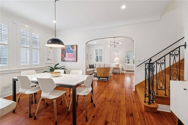 5930 Memphis St, New Orleans, LA 70124 - dining space with arched walkways, plenty of natural light, hardwood / wood-style floors, stairway, and recessed lighting