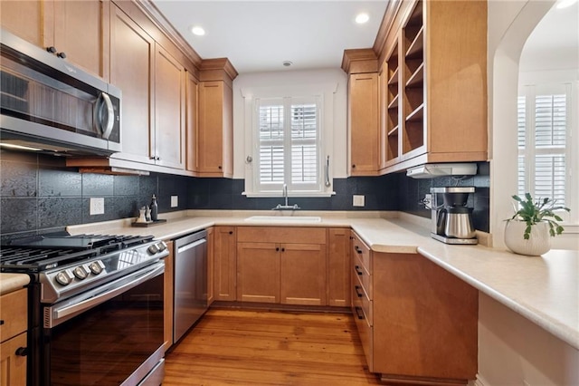 5930 Memphis St, New Orleans, LA 70124 - kitchen featuring appliances with stainless steel finishes, healthy amount of natural light, a sink, light wood-style flooring, and recessed lighting