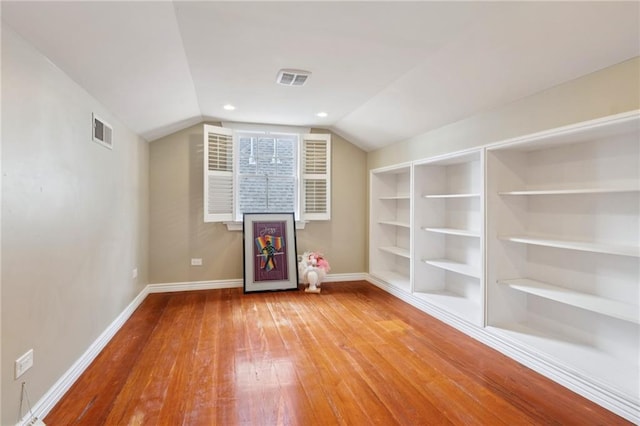 5930 Memphis St, New Orleans, LA 70124 - bonus room featuring hardwood / wood-style flooring, baseboards, built in shelves, and lofted ceiling