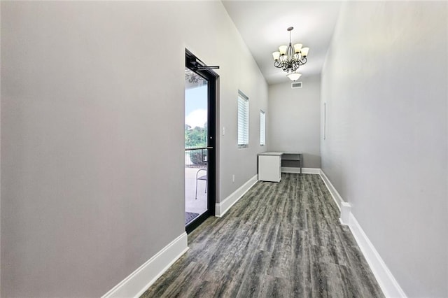 1400 Woodland Hwy, Belle Chasse, LA 70037 - corridor featuring a chandelier, baseboards, and dark wood finished floors